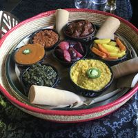 Veggie platter with rolls of injera bread at Zaion Horn of Afrika in Umea