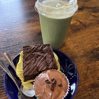 Matcha latte, vegan brownie, and vegan chocolate cheesecake 😋  at Cavegirl Coffeehouse in Longmont