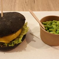 Burger with charcoal bun + edamame beans at Gourmet Burger in Paris