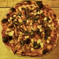 Pizza with bbq sauce, no cheese, grilled pineapple, roasted garlic, jalapeño, and shiitake bacon  at Union Woodshop in Clarkston