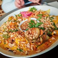 Jack Nachos, nachos with homemade cheddar, acar bening, red onion pickles, coriander, shredded jack, peanuts and special monkey sauce
 at Monkey Mood in Bordeaux