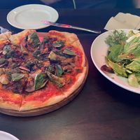 Pizza (artichokes, cashew tahini, caramelised onions and kale pesto) and salad   at Moon Under Water in Christchurch