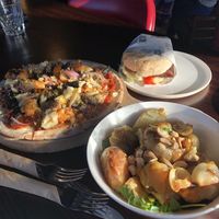 Burger, pizza, and potatoes at Moon Under Water in Christchurch