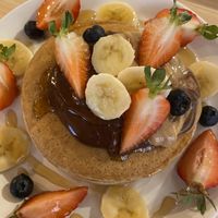 American pancakes with chocolate sauce, peanut butter banana and strawberry at Mukka Coffee in Mallorca