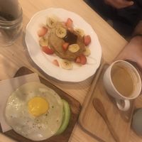 Fried egg avo toast and American pancakes with flat white  at Mukka Coffee in Mallorca