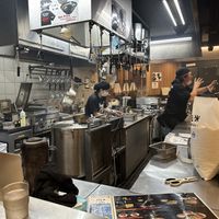 Boss man recording a couple tourists  at Menbaka Fire Ramen めん馬鹿 in Kyoto