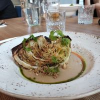 Baked cabbage in white bean puree with mustard seeds and nuts. Divine combination of flavours  at Spojka Karlin in Prague
