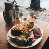 Vegan breakfast burrito baked with gauc and a side of veggie bacon at The Burrow in Vancouver
