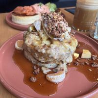 Vegan “Madame Julia” pancakes, with mashed banana, apple and mandarin, vegan whipped cream and nuts, and maple syrup at Madame Julia in Strasbourg