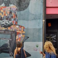 admiring and reading amazing collages ideas and phrases on Palermo walls at Florentine Vegan Experiences in Buenos Aires