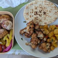 Salad Box and sides of spicy potatoes and cauliflower at Mr Falafel in West London
