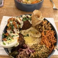 Chef’s plate with cauliflower shawarma plate in the backgroundd  at Pois Chiche in Brussels