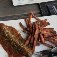 Vegan seitan currywurst with sweet potato fries  at De Lux Curry in Sylt