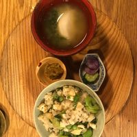 A wholesome rice dish featuring beans and parsley, paired with homemade sesame salt, miso soup, and a selection of traditional Japanese pickles. at Chakura in Sakaishi