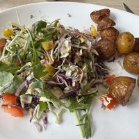 Side salad with vinaigrette and side of roasted potatoes    at Cafe Esmeralda in Nuuk
