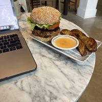 Burger with house habanero hot sauce and rosemary potato wedges   at Lamara Coffee and Kitchen in New Orleans