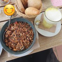 Vegan granola with fresh fruit and soy yogurt, a vegan croissant and an orange juice latte at NaturKost-Bar in Eckernfoerde