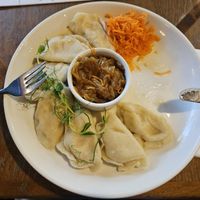 Dumplings with potatoes and tofu, served with white onion. at Pierogarnia Mandu Centrum in Gdansk