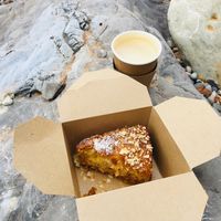 Yummy takeaway vegan coconut and lime cake and coffee, on stones throwaway beach! at The Hideaway in Seaton