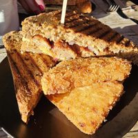 Sausage, red onion, smoked cheese & mustard mayo toastie with hash browns at PEACH in Newport