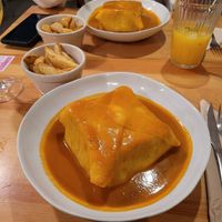 francesinha with potato wedges at Kind Kitchen in Porto