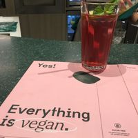 Iced tea of the day (red fruit, lime and mint) with the menu.   at Kind Kitchen in Porto