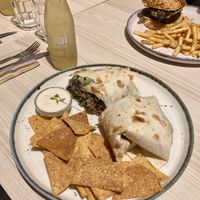 Supreme burrito, seitan burger on the backround  at Kind Kitchen in Porto