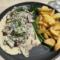 Seitan steak with mushrooms and gravy and fries  at Kind Kitchen in Porto
