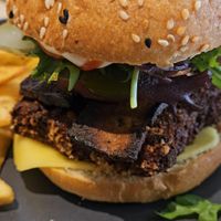 Overcooked Seitan and Bacon burger at Kind Kitchen in Porto