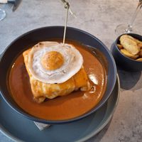 Francesinha with a vegan fried egg and wedges. at Kind Kitchen in Porto