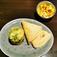 Vegan roti with bowl of tofu and chickpeas at Klein Paramaribo in Assen