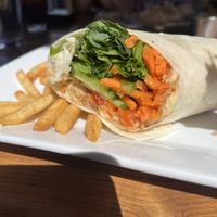 Trailhead wrap with hummus, cucumber, avocado and carrots— took the picture after eating the first half 😂 got guacamole on the side and fries.   at Trapper Grill in Moran