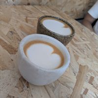 Flat white (back) espresso macchiato (front) with oat milk at Estratto in Brescia