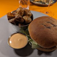 Vegan burger with mushrooms. Side of crispy new potatoes and sauce. at Midgard Restaurant & Bar in Hvolsvollur