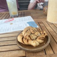 Cardamom bun (€4) and ginger iced tea in the background🥤  at Mahalo in Groningen