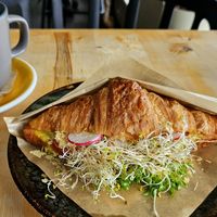 Savory croissant with sausage, cheese sauce, and a lot of sprouts at Rohe in Tallinn