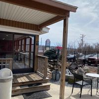 Outdoor seating area with a view of the screened in porch seating.  at The Pink Bean in Somerset