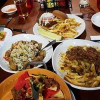 Poutine, burger, nachos & rice dish at Three Dollar Deweys in Portland