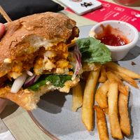 Half eaten buffalo cauliflower vegan burger at Noosa Reef Hotel in Noosa Heads
