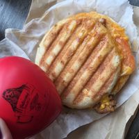 tempeh bacon & Daiya cheddar breakfast sandwich with a sloth squeezie toy!  at Delicious Cafe in Chicago