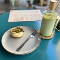 Pistachio cheese cake with iced matcha latte  at LUUC Café in Saarbrucken