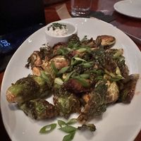 Spicy brussels sprouts with an incredible vegan dipping sauce. My fiancé and I said how did they make this yummmm  at The Port Hunter in Edgartown