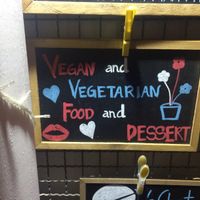 Sign outside the bar at Roots Experience in Lisbon