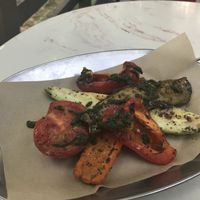 Grilled veggies with pesto sauce. About 1/4 eggplant and zucchini, 1/2 a tomato and bell pepper, and one long strip of carrot. Very filling and deliciously seasoned.  at 8oz in Moscow
