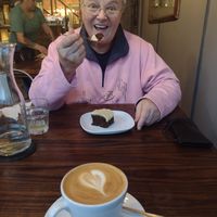 Lovely friend tucks into vegan gingerbread cake & oatmylk latte. at Rialto in Eyemouth