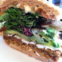 Golden Mean burger with tortilla chips, side view. at Golden Mean in Santa Monica