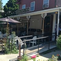 Front entrance with outdoor seating at Harlow's Pub in Peterborough