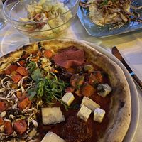 Pizza in front, mixed salad and the culurgiones on the rightt  at Rocca Ja in Castelsardo