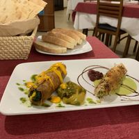 Rolled Sardinian flatbread with sauteed greens and rolled pasta filled with vegetables.  at Il Portico in Nuoro