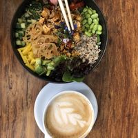 Large spicy tofu poke bowl and oat latte  at Leaves House || in Montreal
